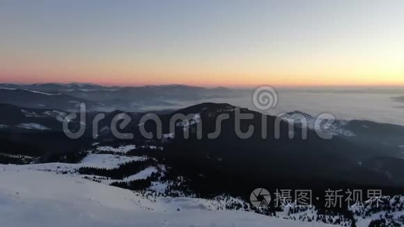 美丽的群山覆盖着雪和惊人的日落，背景上有五颜六色的天空，4K