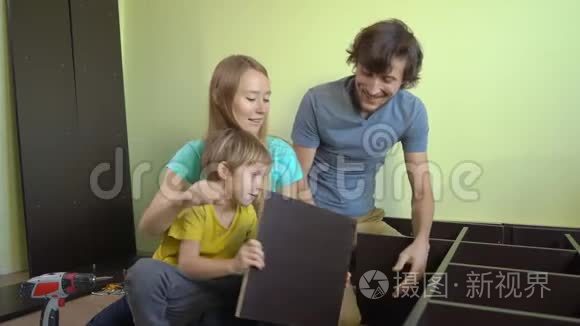 年轻的一家人用架子组装橱柜视频