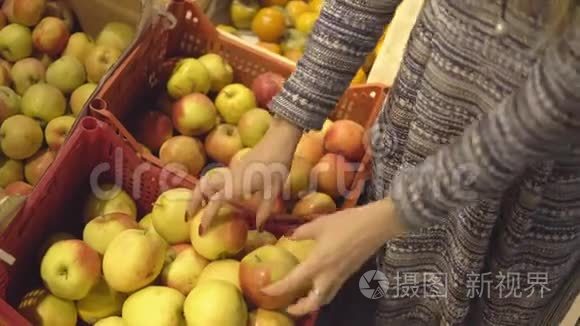 在水果蔬菜超市选择苹果的女人的手