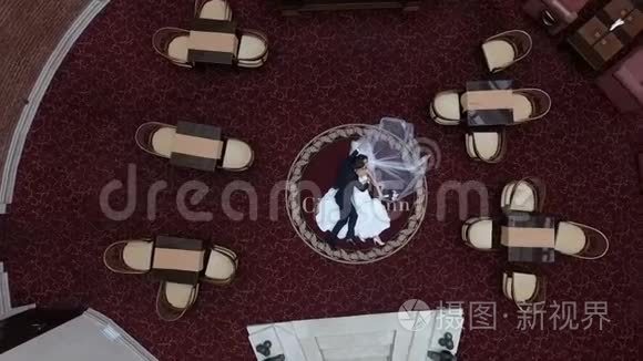 顶级婚礼肖像，美丽时尚的新婚夫妇拥抱，躺在豪华酒店的红地毯上。