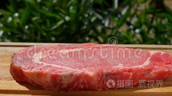 香料落在木板上的猪肉牛排上