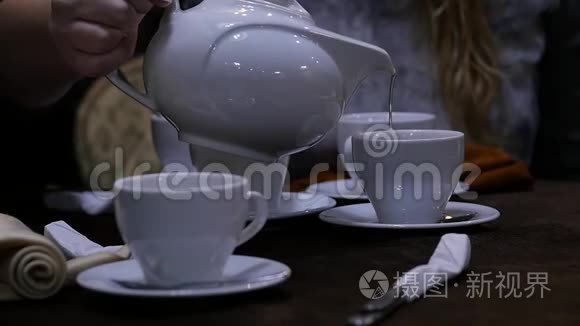 女人在咖啡馆里用白色杯子倒凉茶。 慢动作