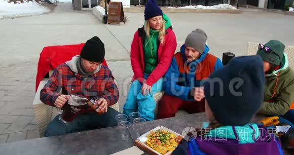 在篝火旁吃零食的朋友视频