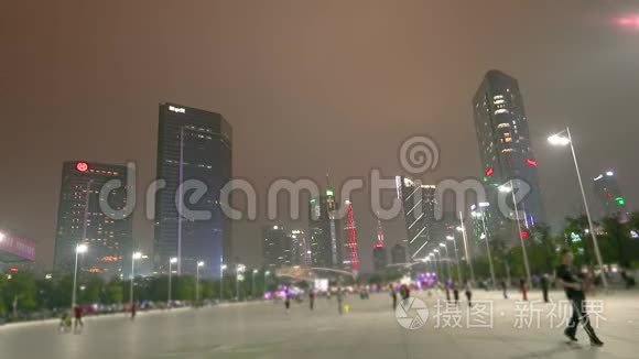 人们走在北京夜街，背景是摩天大楼。 广州大型步行街