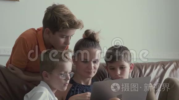 有小儿子的女人在家里用笔记本电脑看电影