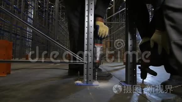 男子在仓库中使用钻架工作视频