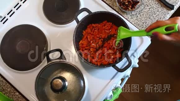 那个女人正在搅拌油炸的胡萝卜片.
