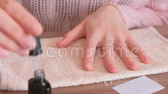 女人在涂黄油之前先涂指甲底漆。 特写双手。