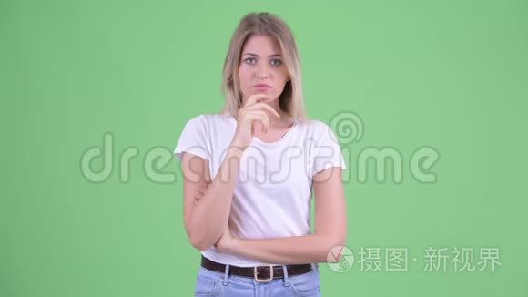 一个年轻的金发女郎在思考,低头看着短视频