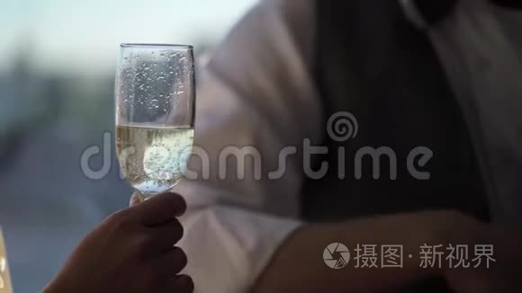 一对年轻夫妇拿着香槟碰杯