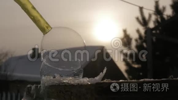 霜肥皂泡。 冰冻的雪球。 雪花冰纹结霜在肥皂球上。 冬季日落背景