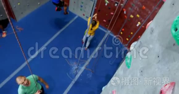 男子和女子在健身室练习攀岩视频