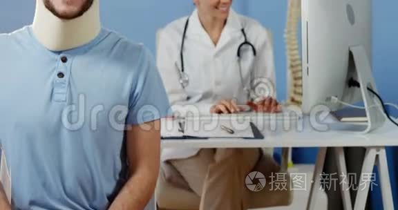 病人在镜头前微笑，而女性理疗师则在后台工作