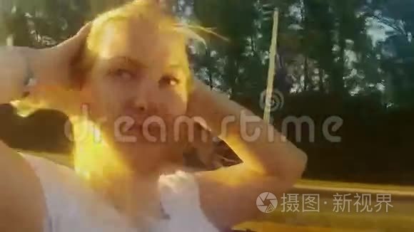 年轻的金发女人坐在敞篷车里视频