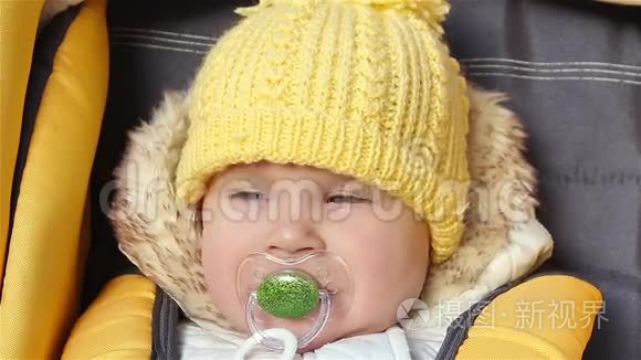 婴儿坐在婴儿车厢里,奶嘴在吮吸短视频