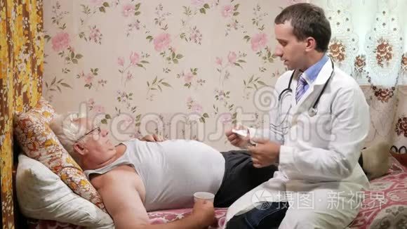 一个男医生在家里生病时给他吃药. 那人正在喝水，躺在沙发上。