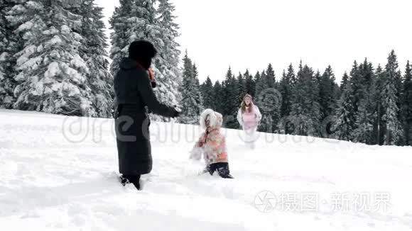 妈妈和两个孩子在冬天玩雪