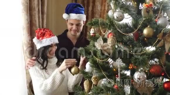 快乐的一对夫妇装扮圣诞树视频