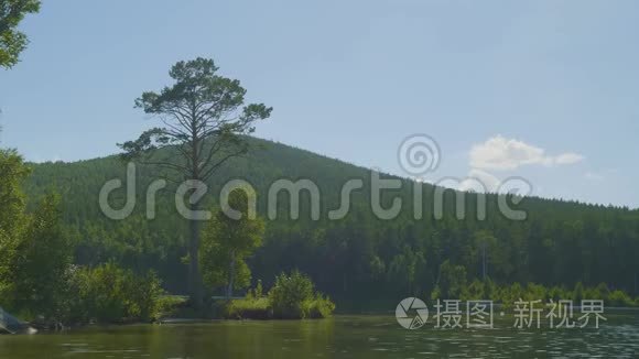 夏日傍晚日落时湖边美丽的景色。一些云从静水中反射出来。日出