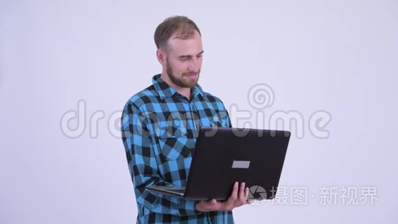 喜欢留胡子的时髦男人在用笔记本电脑思考
