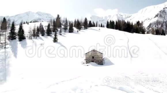 有小木屋和松树的雪山