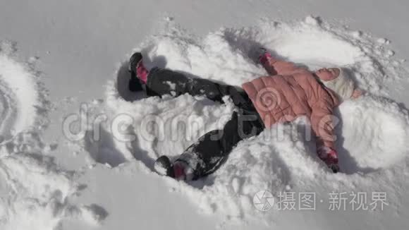 美丽的小女孩做雪天使