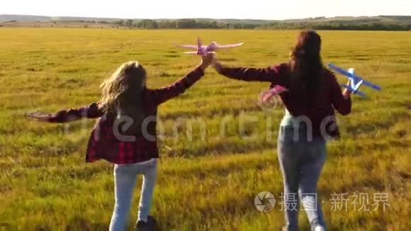 孩子们在飞机上玩耍的剪影。 飞行的梦想。 快乐的童年概念。 两个女孩玩玩具飞机