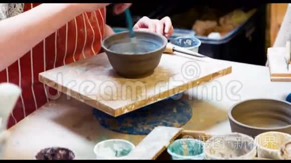 女艺术家在陶器碗上作画视频