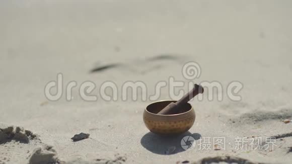 在沙滩上打坐的青铜藏语唱碗