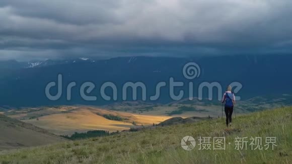 女人徒步旅行。 在山上远足。 带背包的女旅行者在美丽的夏季景观上。