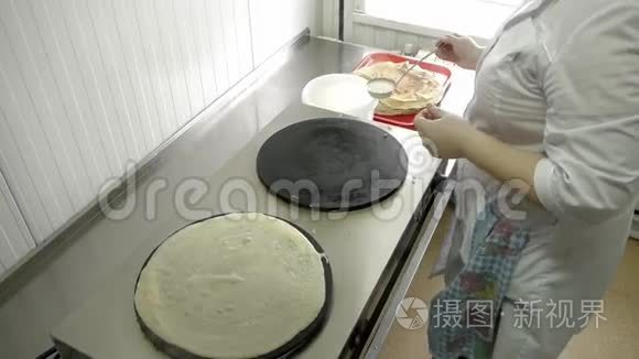 女人在炉子上做煎饼视频