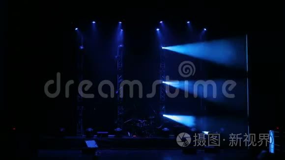 白色和蓝色的美丽光线在音乐会前的一个空舞台上。