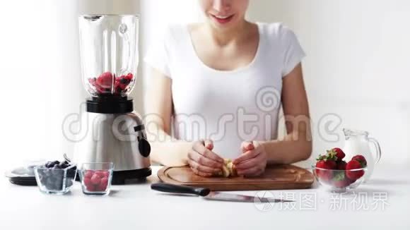 微笑的女人用搅拌机做水果奶昔视频