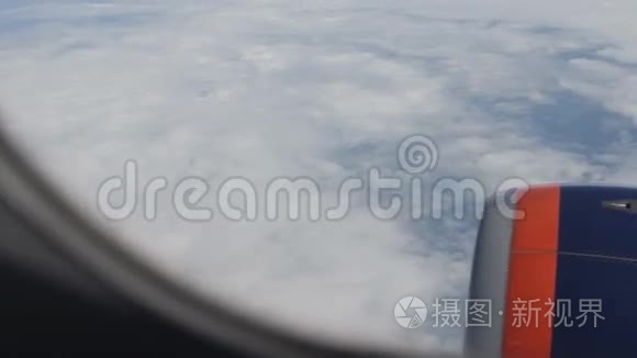 客机机翼。透过窗户的景色。云层之上