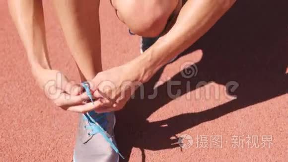 女运动员坐着系鞋带视频