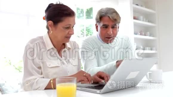 印度老夫妇在家使用笔记本电脑