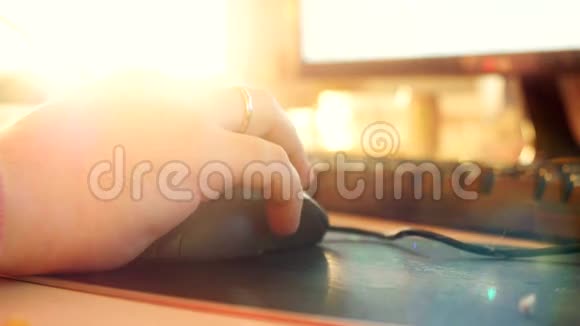 关闭男性手在电脑键盘和鼠标打字与改变焦点和镜头耀斑与阳光。 4k视频的预览图