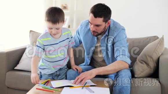爸爸和小儿子在家里画蜡笔