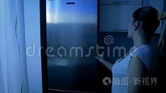 年轻微笑的女人从冰箱里拿食物视频