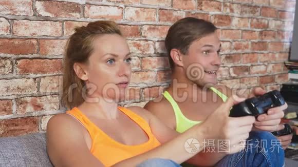 情绪化的男人和女人在控制台上玩操纵杆,他们竞争并制造疯狂的滑稽