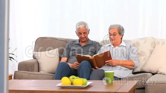 年长夫妇正在看他们的相册视频