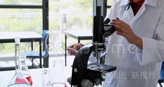 女生在实验室做显微镜实验视频