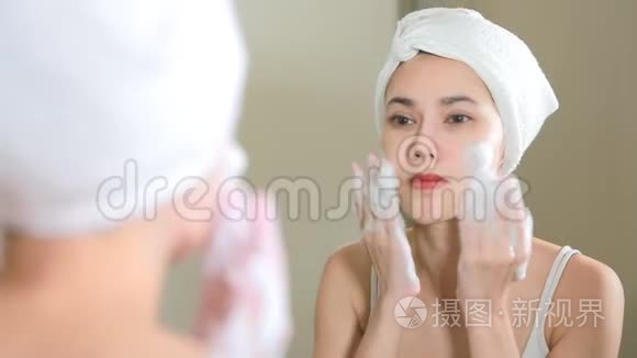 女人在浴室用泡沫洗脸