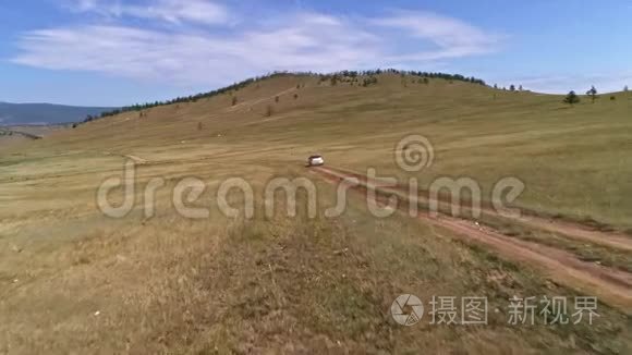 空中镜头拍摄与无人驾驶皮卡在草原。 汽车沿着草原行驶到西伯利亚，铺设道路
