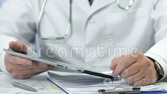 男性医生在平板电脑上打字、插入数据、医疗改革